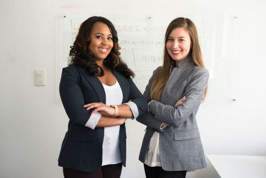 Two professional women standing in an office